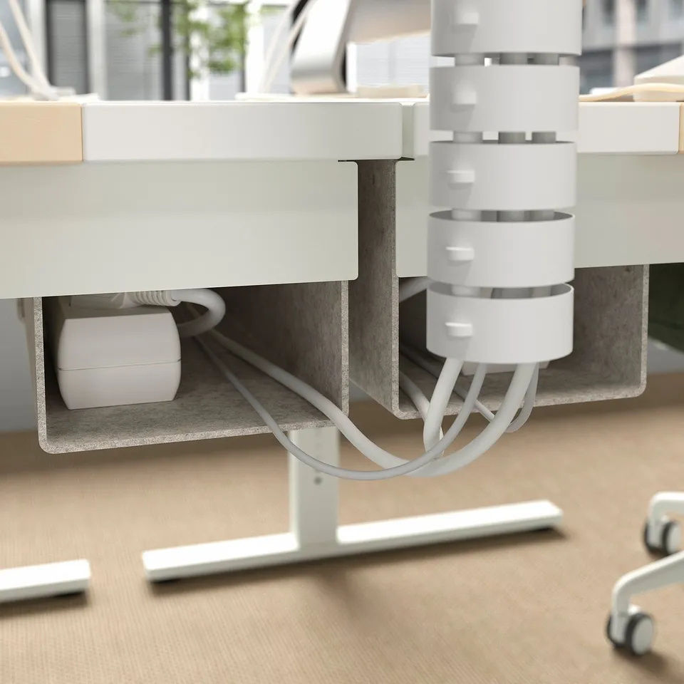 Desk with cable management tray and adjustable motorised height.