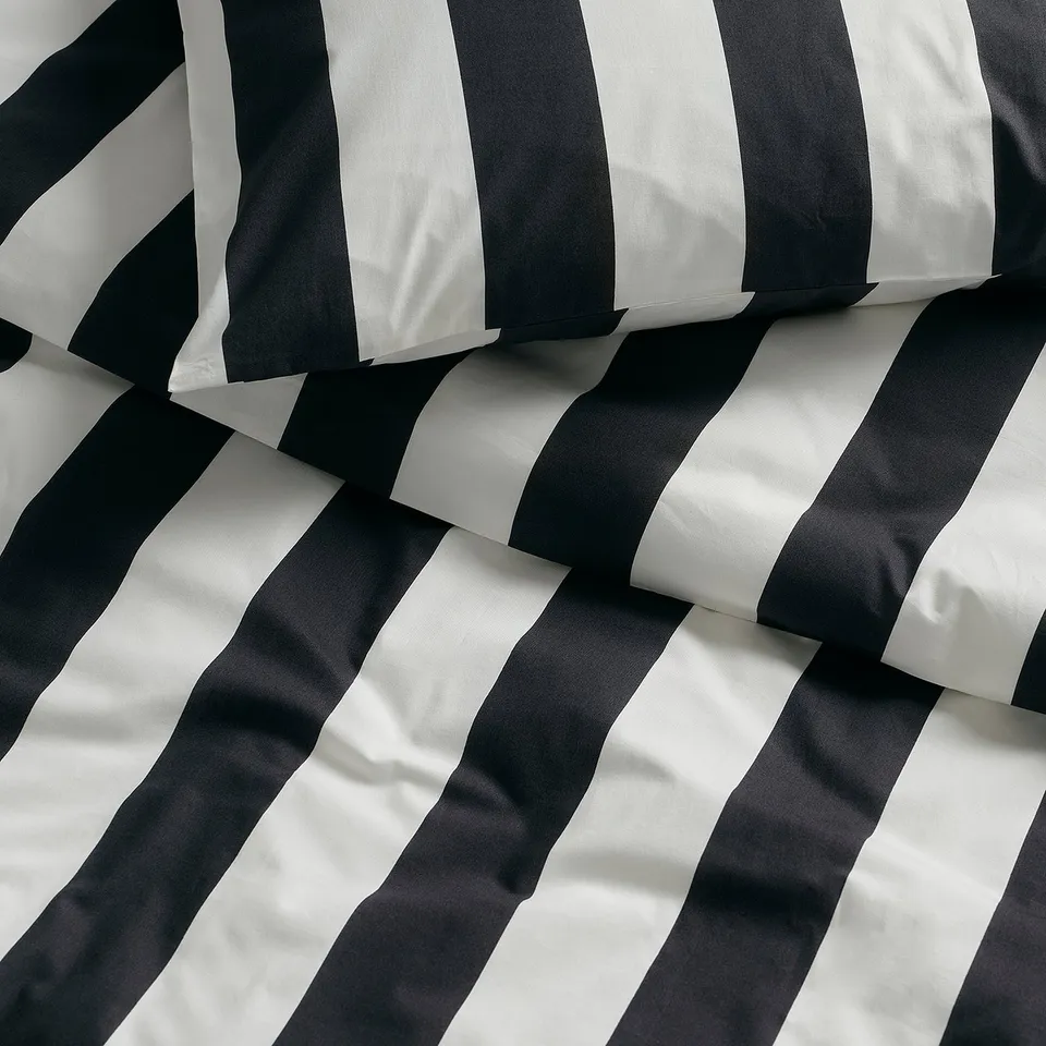 Black and white striped duvet cover, neatly folded, showcasing crisp, durable percale weave.