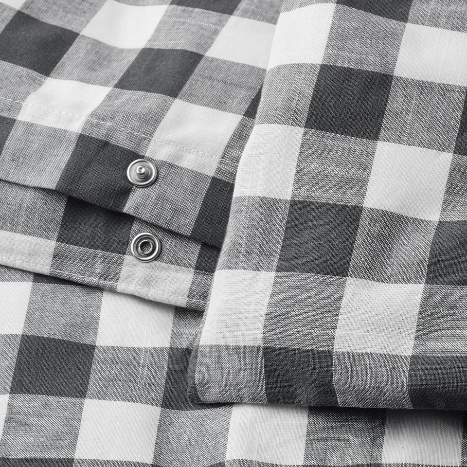 Black and white chequered duvet cover with metal snap closure. Made from organic cotton.