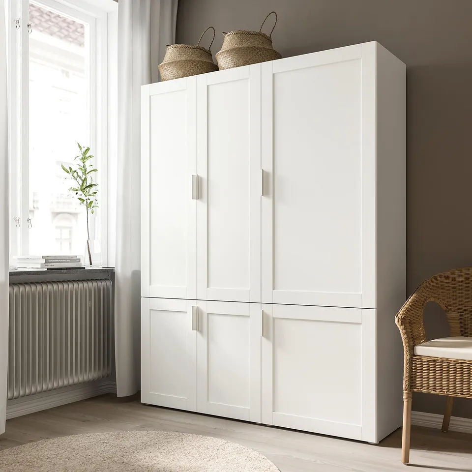 White SANNIDAL cabinet with four doors by window. Top baskets, plant, chair.