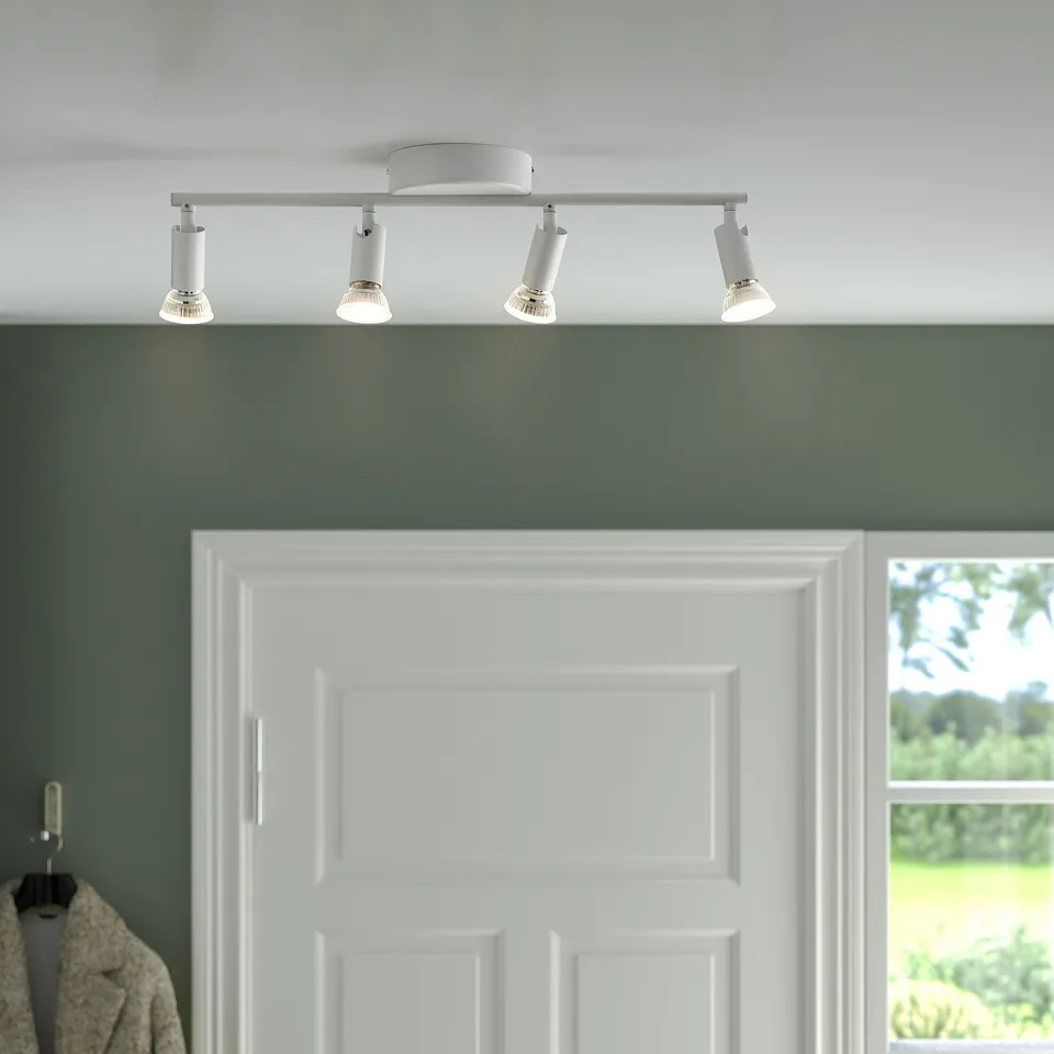 Modern ceiling track light with 4 adjustable spotlights, ideal for hallways or kitchen islands, mounted on a white ceiling.