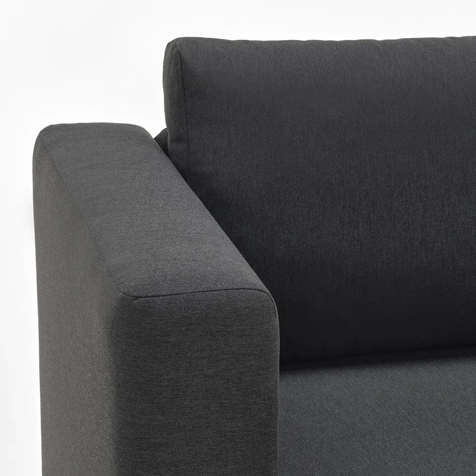 Dark grey sofa with plush cushions, modern design. Well-crafted, inviting comfort.