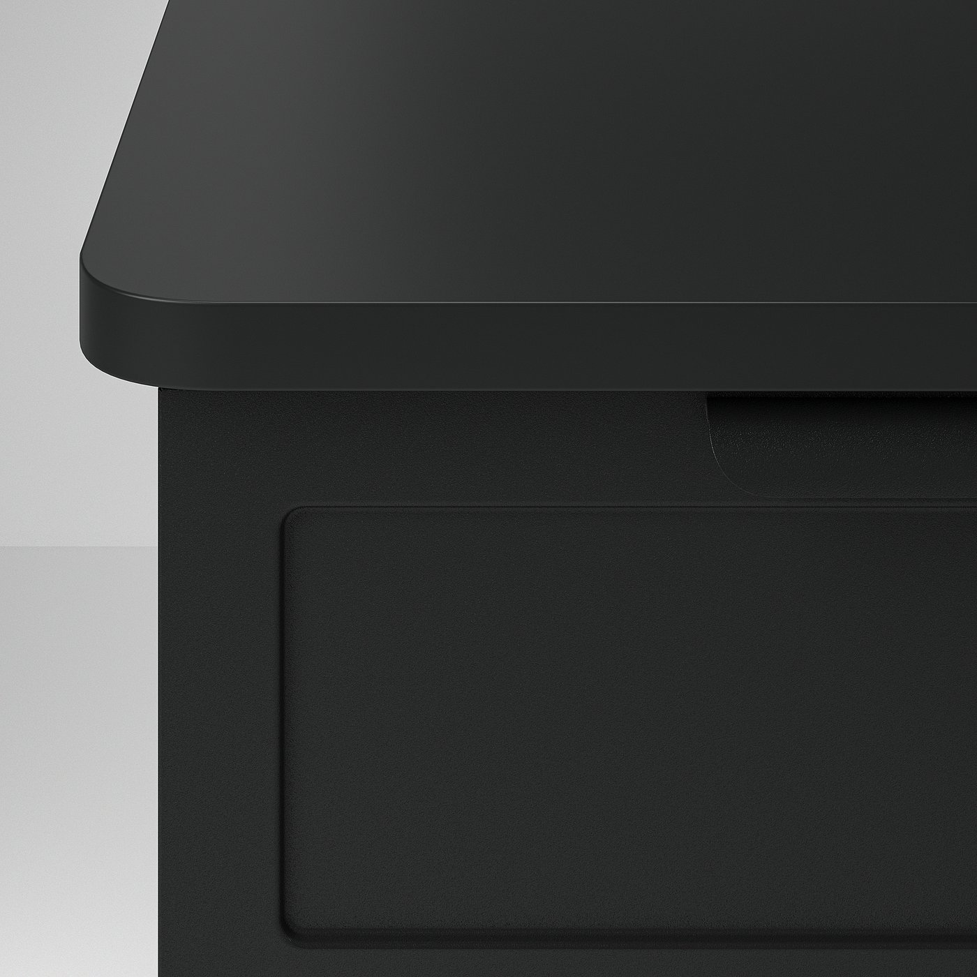 Modern black bedside table with sleek, rounded edges and a flip-open door for hidden storage.