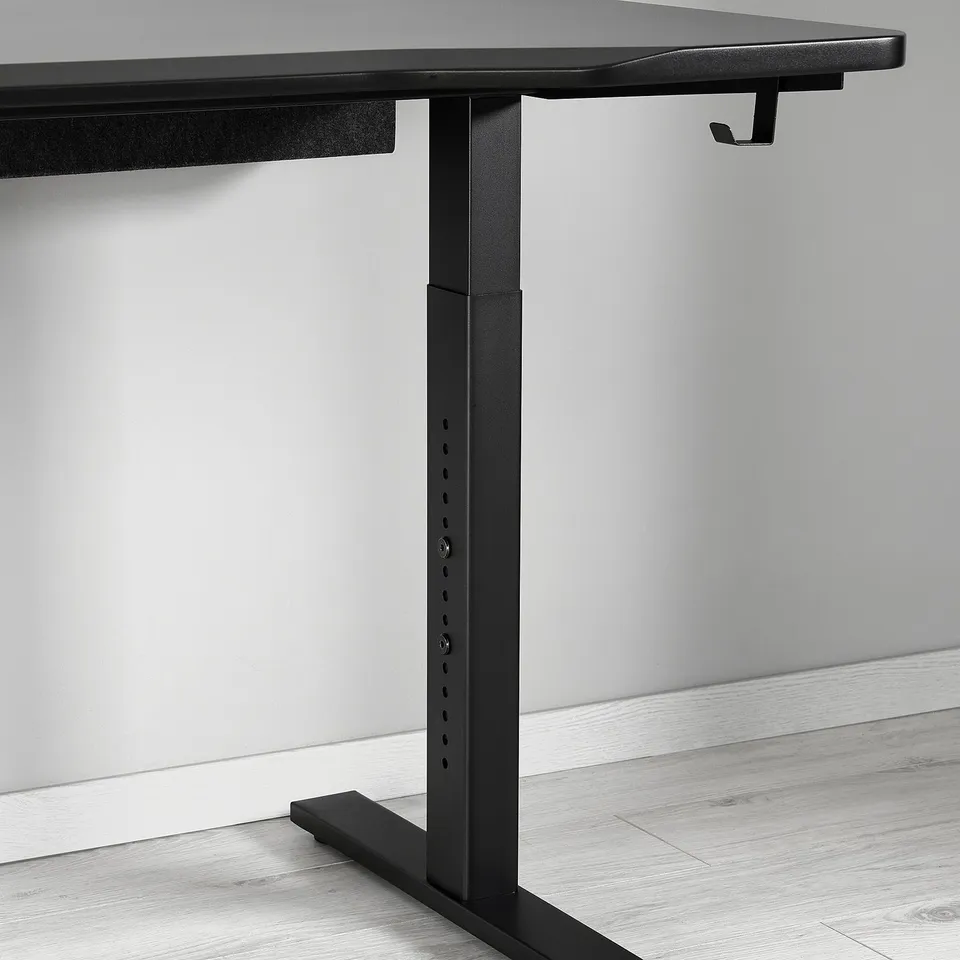 Black adjustable desk with sleek metal legs and cable management solution. Designed for comfort and durability.