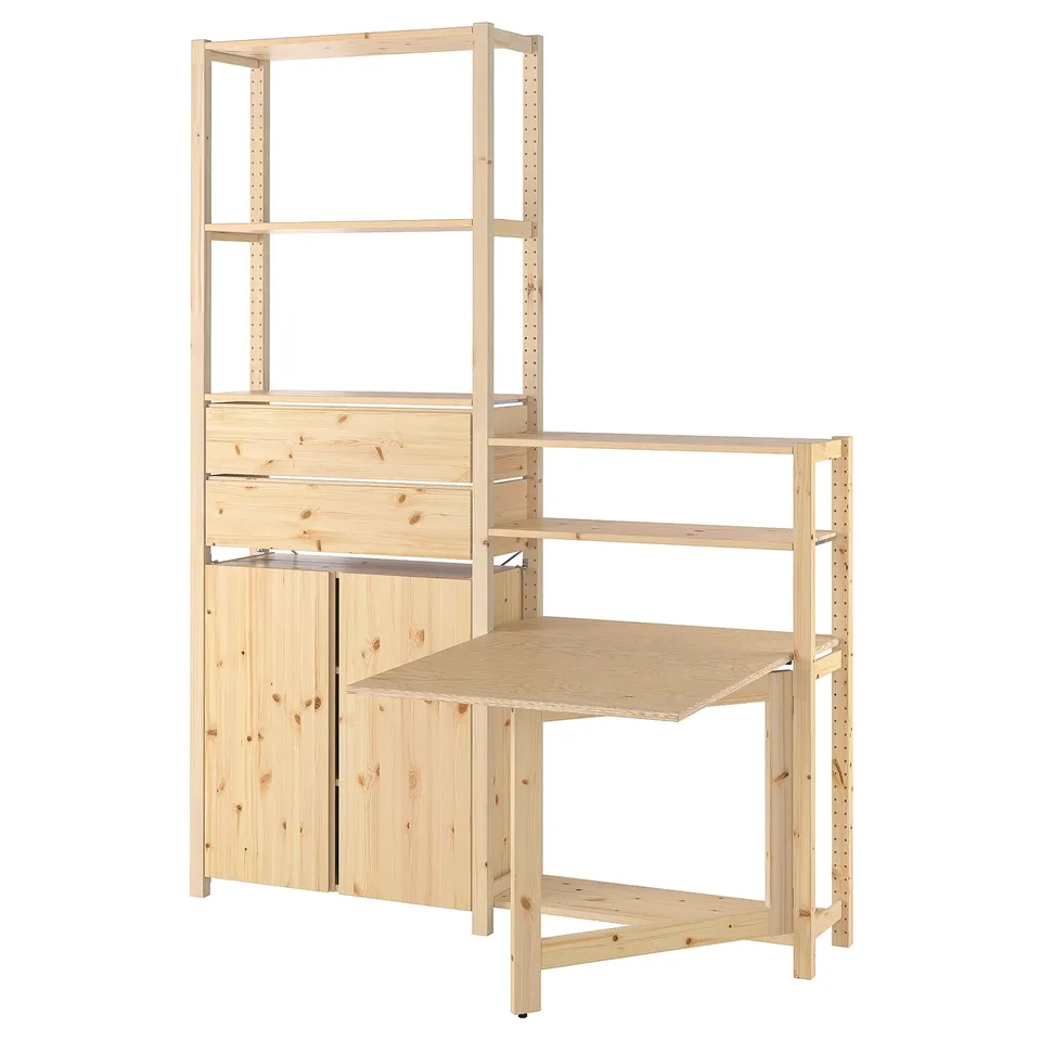 An IVAR wooden storage unit, light brown, with shelves, drawers, and a foldable table. Its modular design offers versatile storage options.