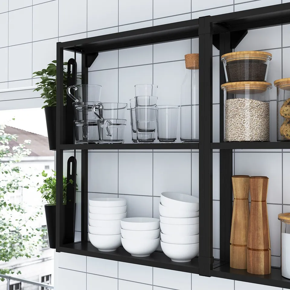 Modern ENHET shelf with glasses, bowls, jars, and plants. Or, to be even more concise: ENHET shelf with kitchenware and plants.