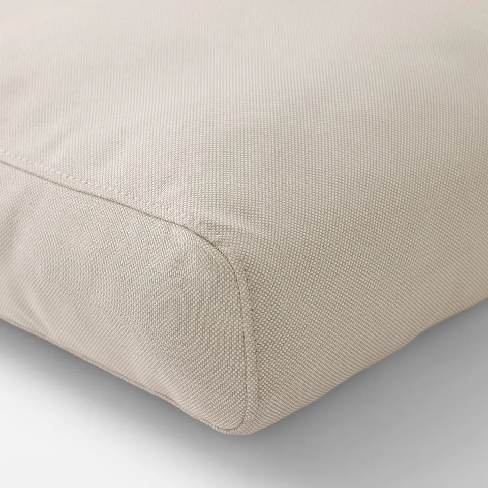 Close-up of premium outdoor cushion, showcasing fine stitching and quality fabric.