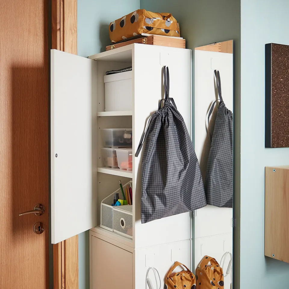 Open white cabinet with RENSARE bags: two grey, two orange polka dot, hanging and storing items.