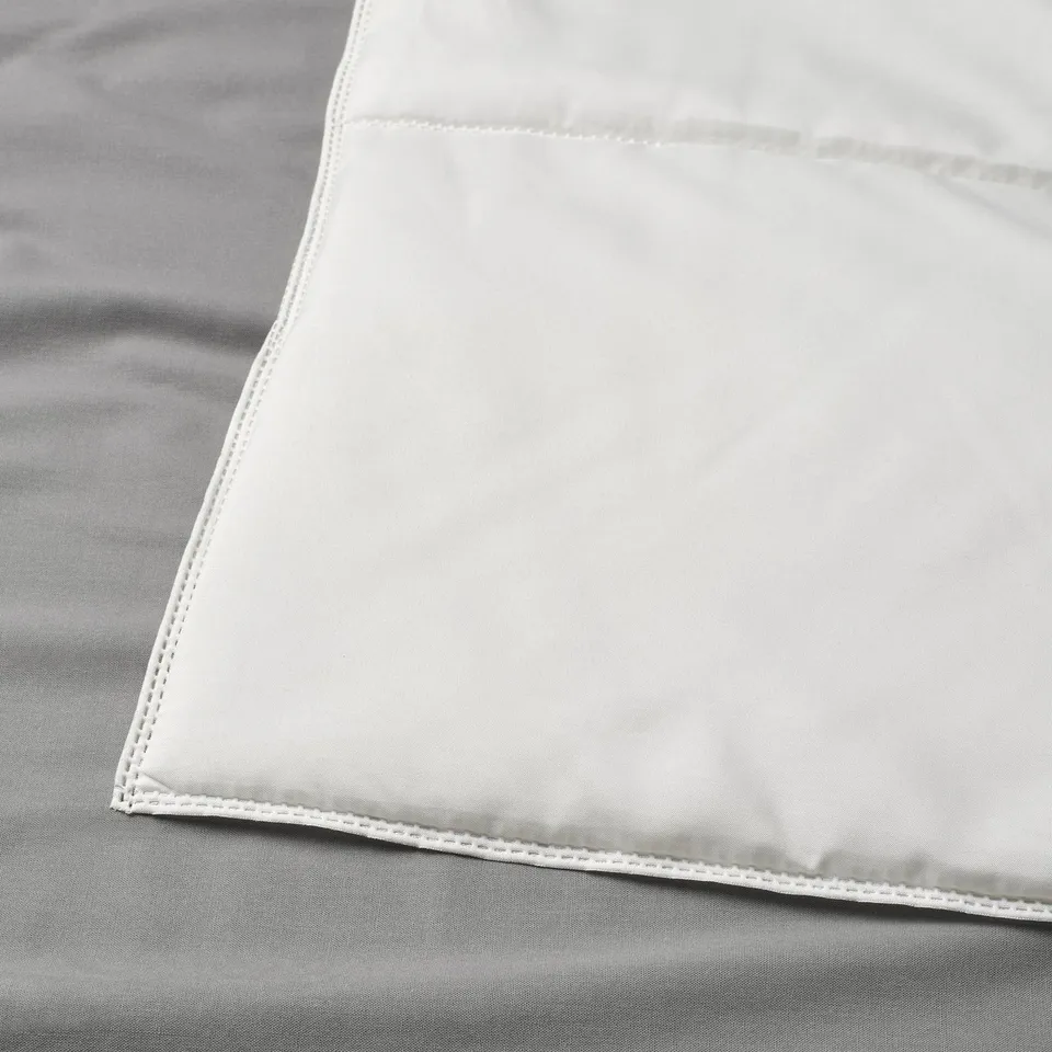 Image shows a neatly folded, high-quality, lightweight duvet with precise stitching, highlighting its durable and smooth fabric texture.
