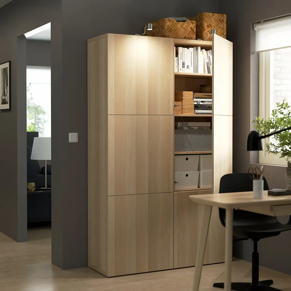 Wooden storage cabinet with adjustable shelves and soft-closing doors in modern home office.