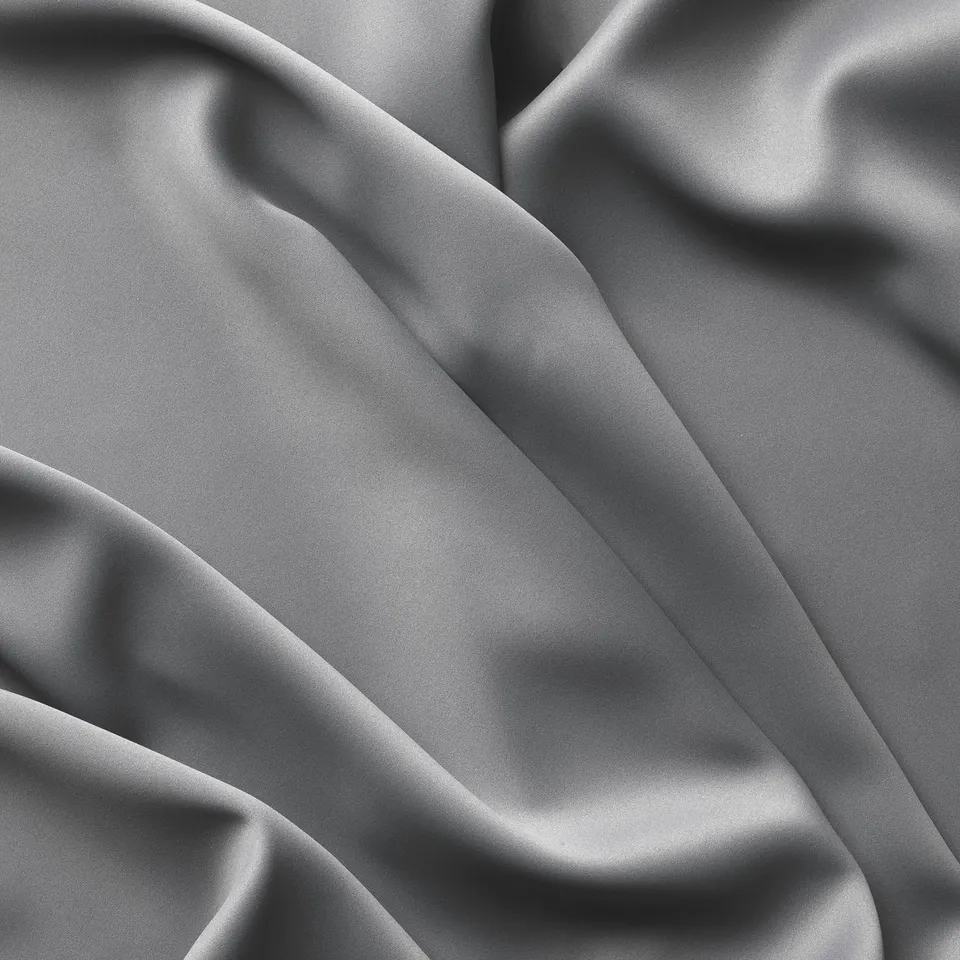 Blackout curtains with smooth, heavy fabric in neutral tones, draped elegantly.