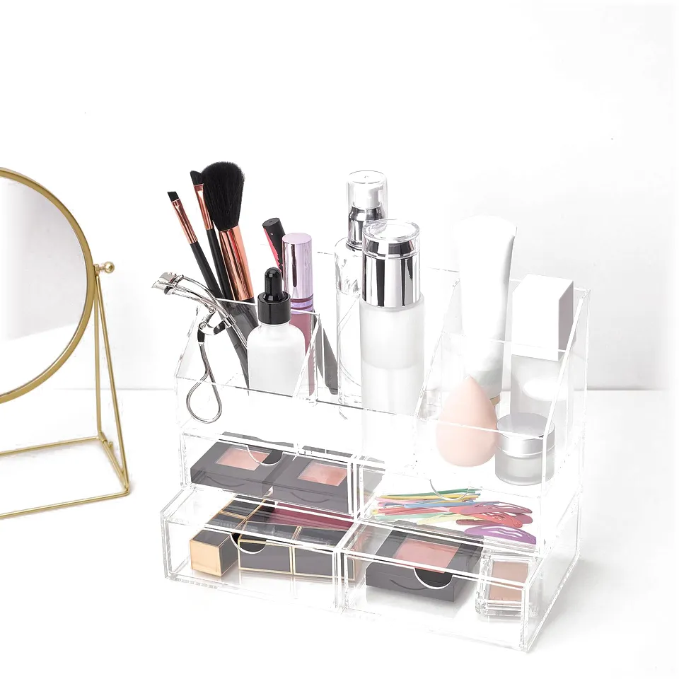 Clear acrylic makeup organiser holds brushes, bottles, and cosmetics with 2 drawers for rings and bracelets.