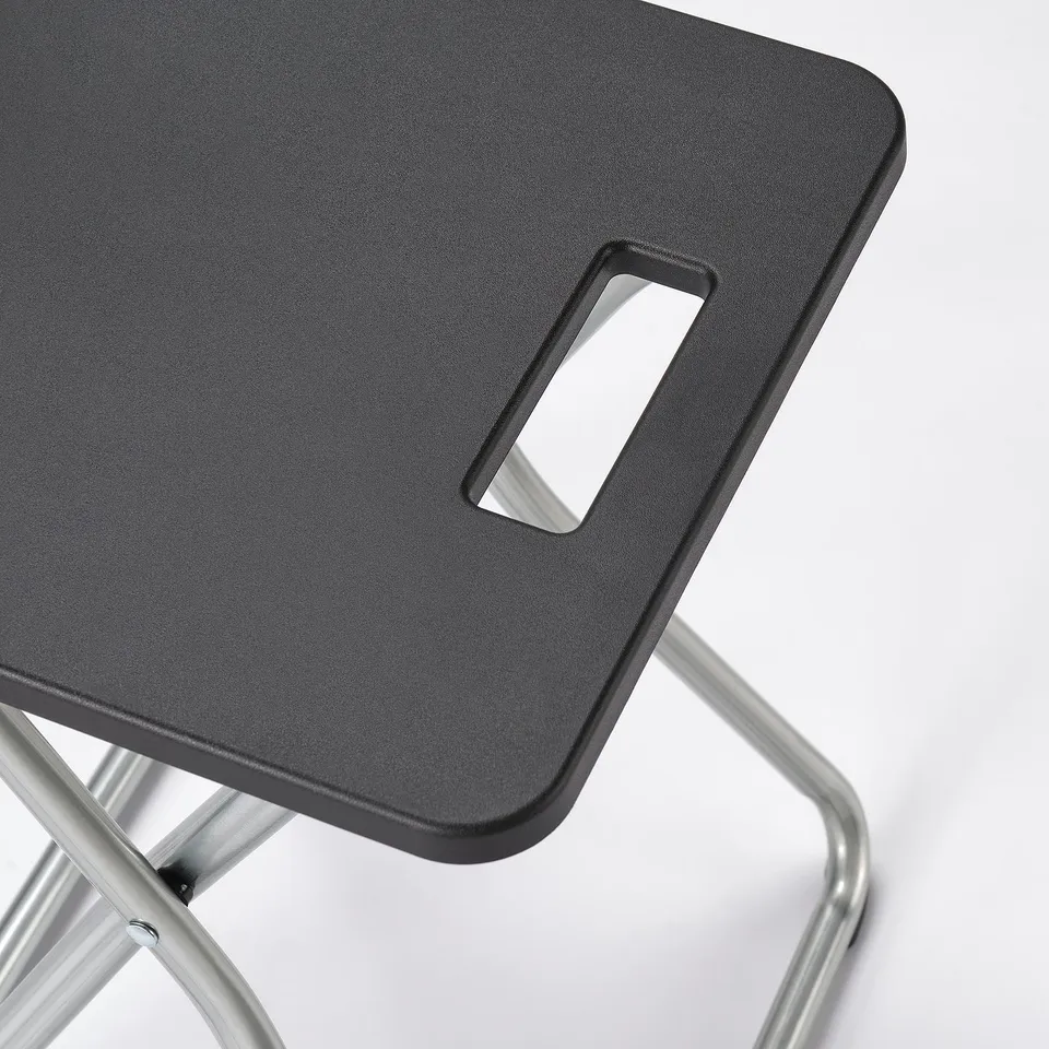 Modern lightweight black stool with metal legs, foldable for easy storage.