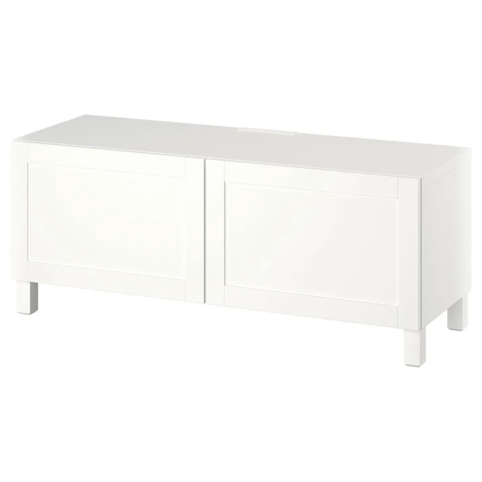 A white BESTÅ tv bench with two doors and adjustable shelves for storing media and hiding cables.