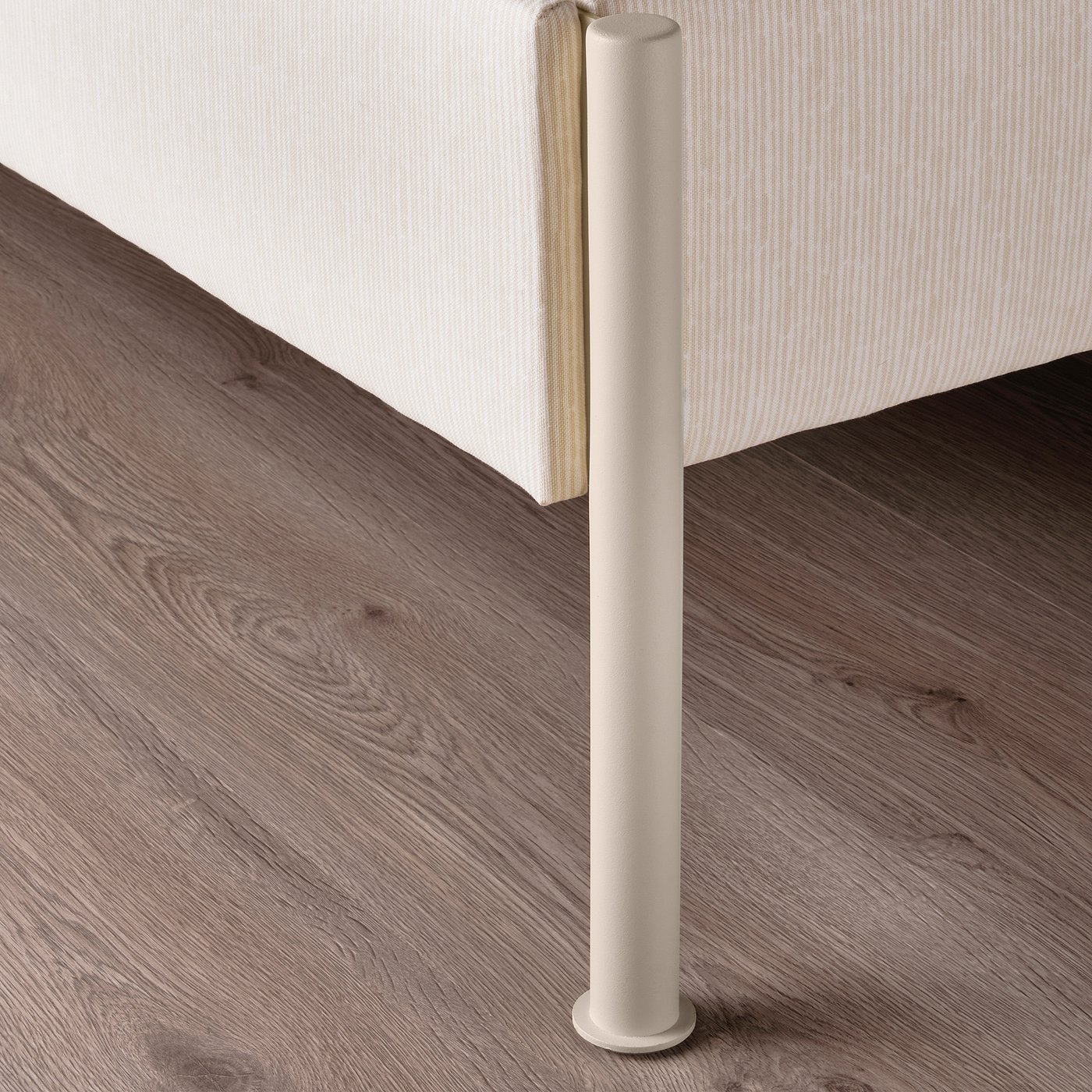 A modern upholstered bed frame with a cylindrical leg and striped headboard, highlighting its clean and sturdy design.