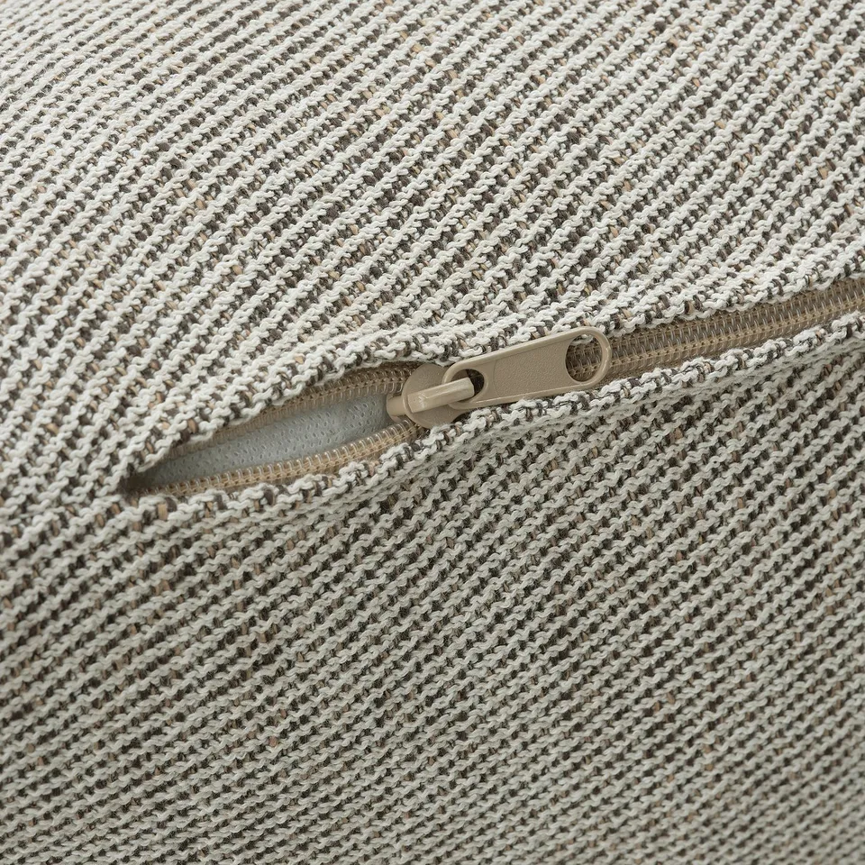 Close-up of well-crafted zip on textured, woven fabric, showcasing high-quality stitching and durable material.