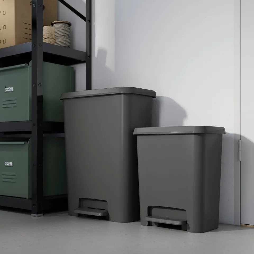 Two grey KNÖCKLA bins beside green shelving for waste sorting.
