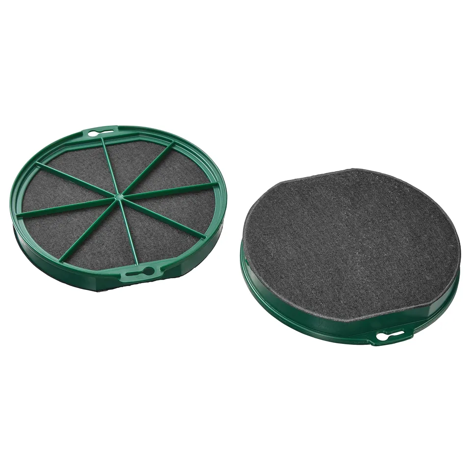 Two green round charcoal philtres, one open showing segments, placed on a white background.