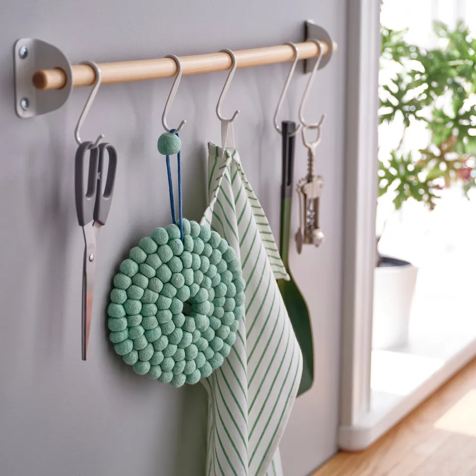Kitchen hooks with tools, plant.