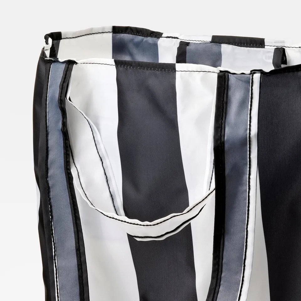 Close-up of SKYNKE bags sturdy, recycled fabric, showcasing strong seams and durable handles.