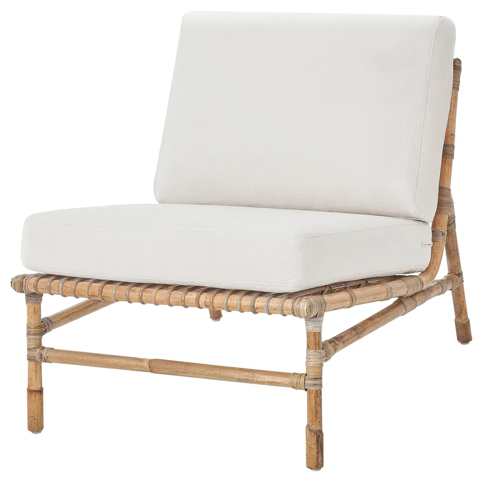 Modern white wicker lounge chair with cushions, natural frame, outdoor design.