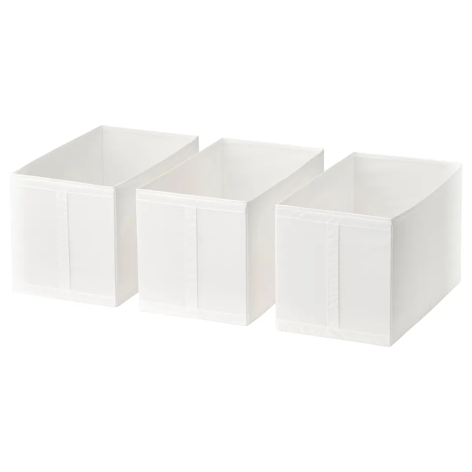 Three white storage boxes, rectangular with handles, stacked side by side, perfect for organising wardrobe items.