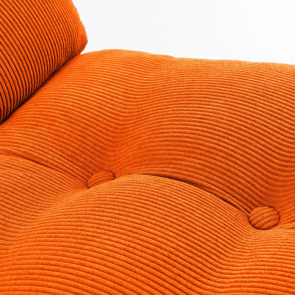 Bright orange textured chair up close, showing detailed corduroy pattern and cushioned design.