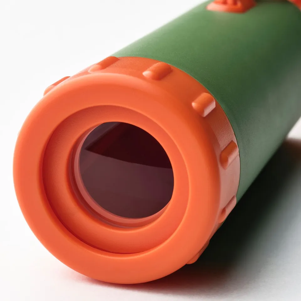 Close-up of a green and orange telescope, showcasing its cylindrical shape, detailed orange rim and sturdy body.