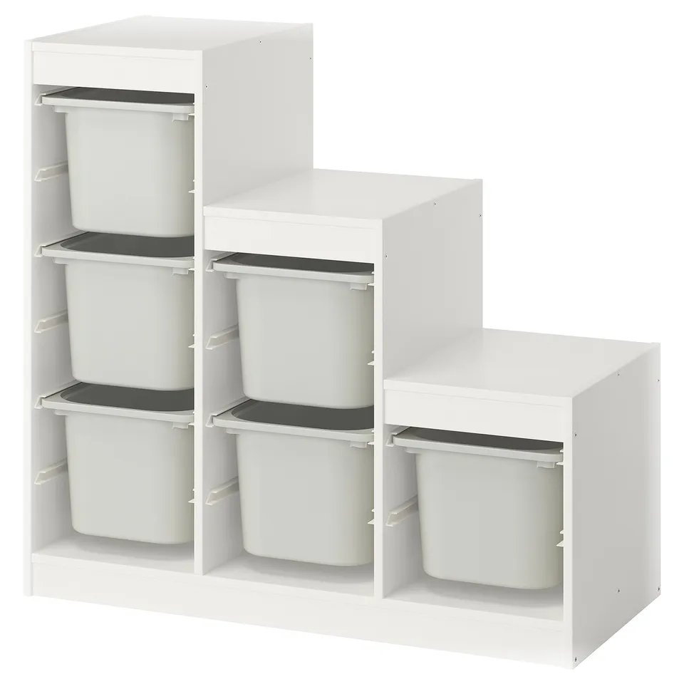 A white TROFAST storage unit with multiple shelves and plastic bins for organising kids toys.