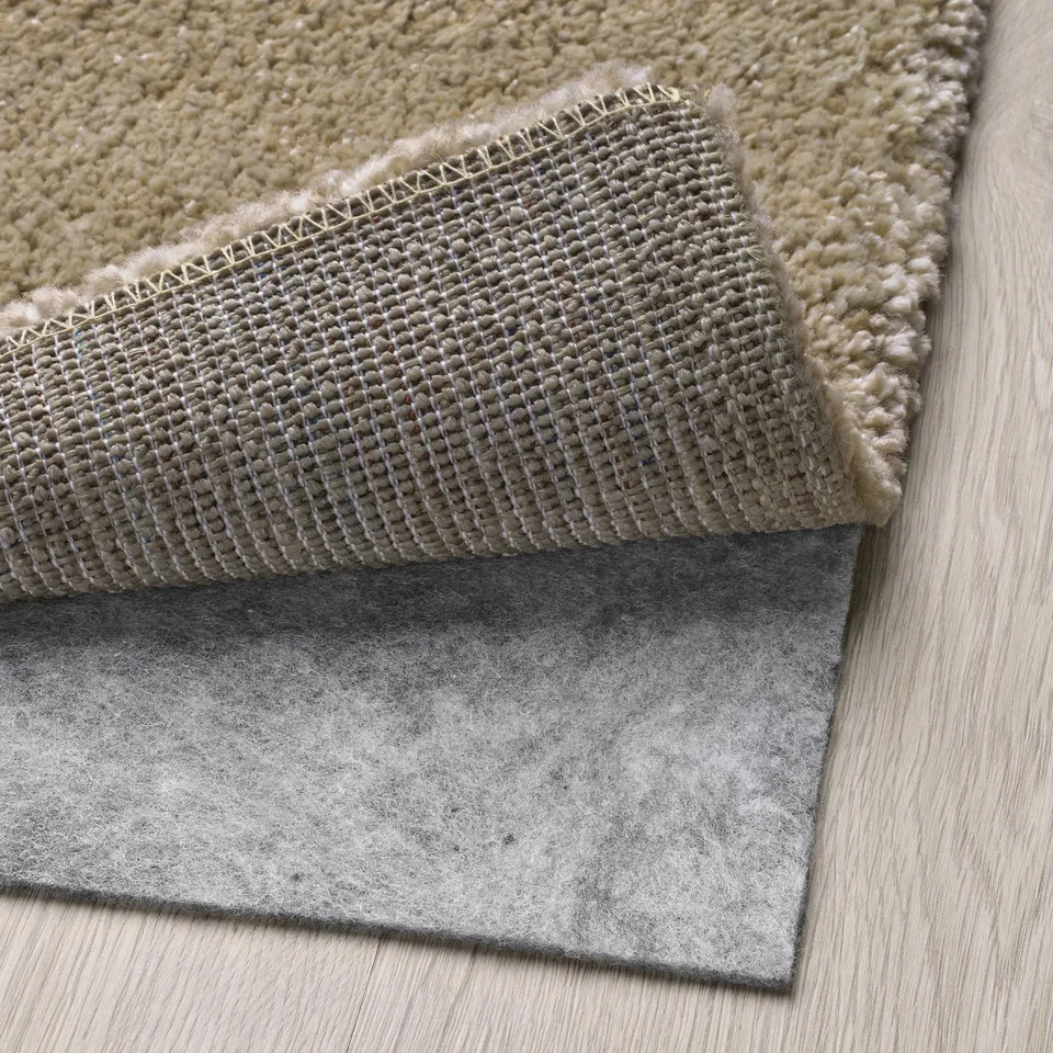 Rug with non-slip mat underneath on wooden floor.