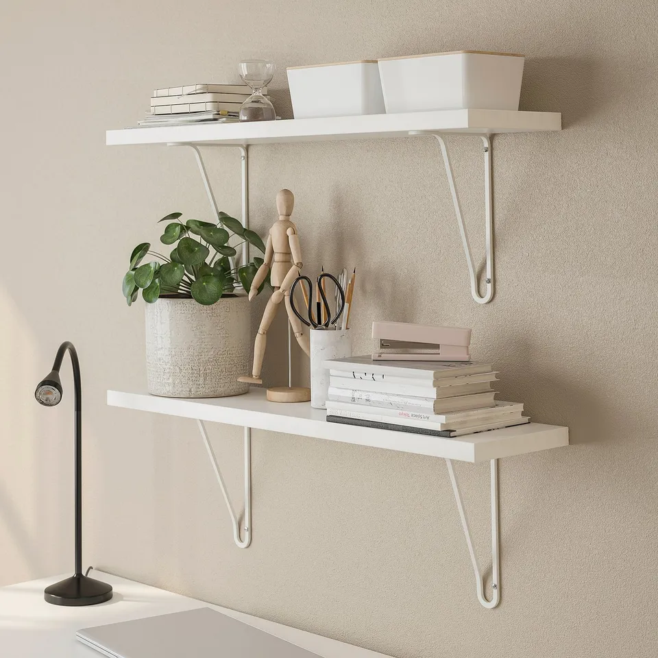 Wall-mounted shelves with books, plant, and boxes, saving floor space.