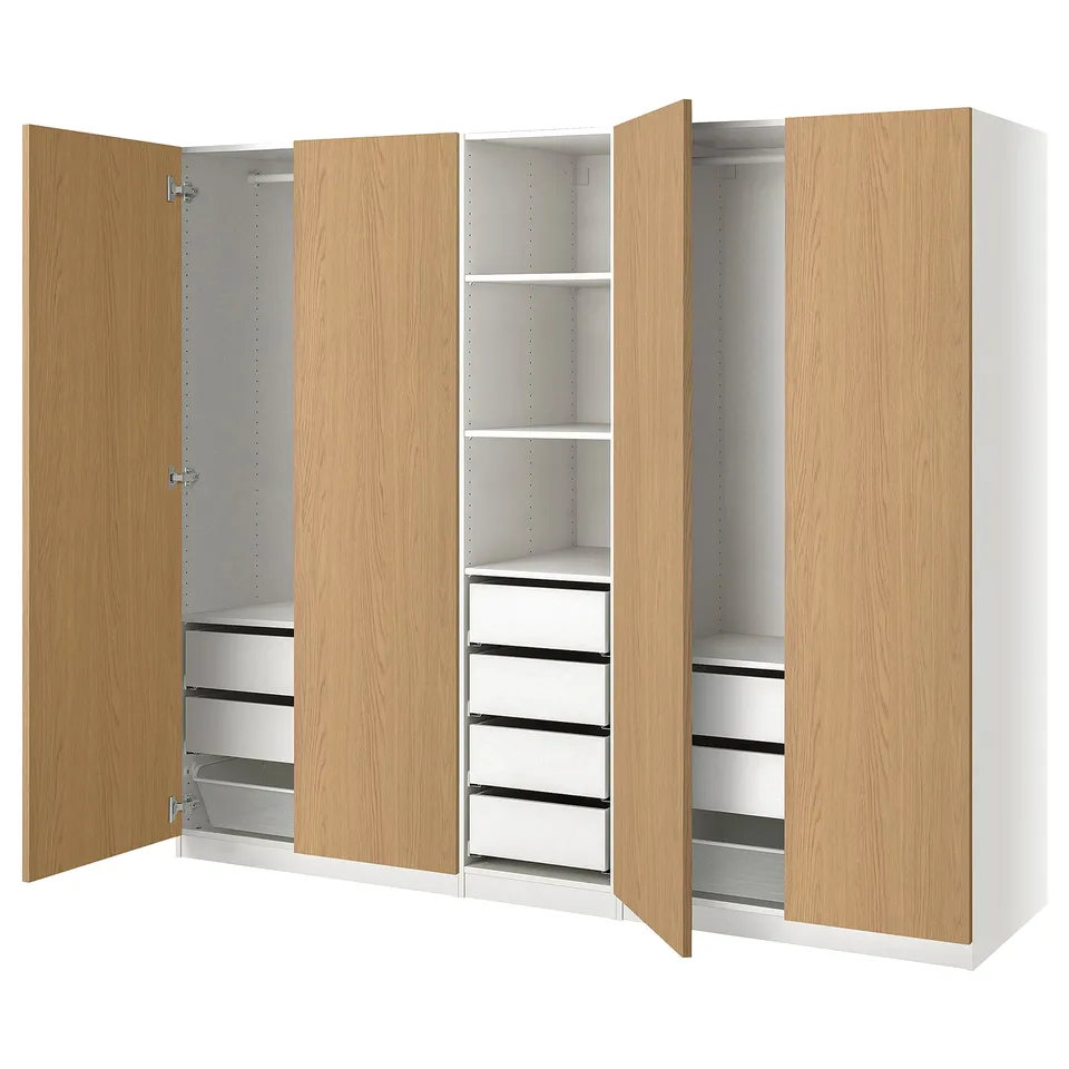Modern light wood PAX wardrobe shows open drawers and shelves, showcasing organised storage. White and wooden tones.