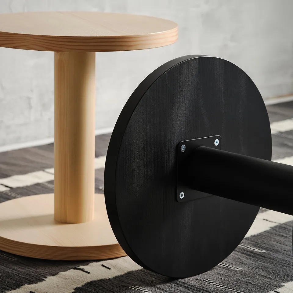 A stylish, modern side table, crafted with natural wood and sleek black accents, showcasing high-quality scandinavian design.