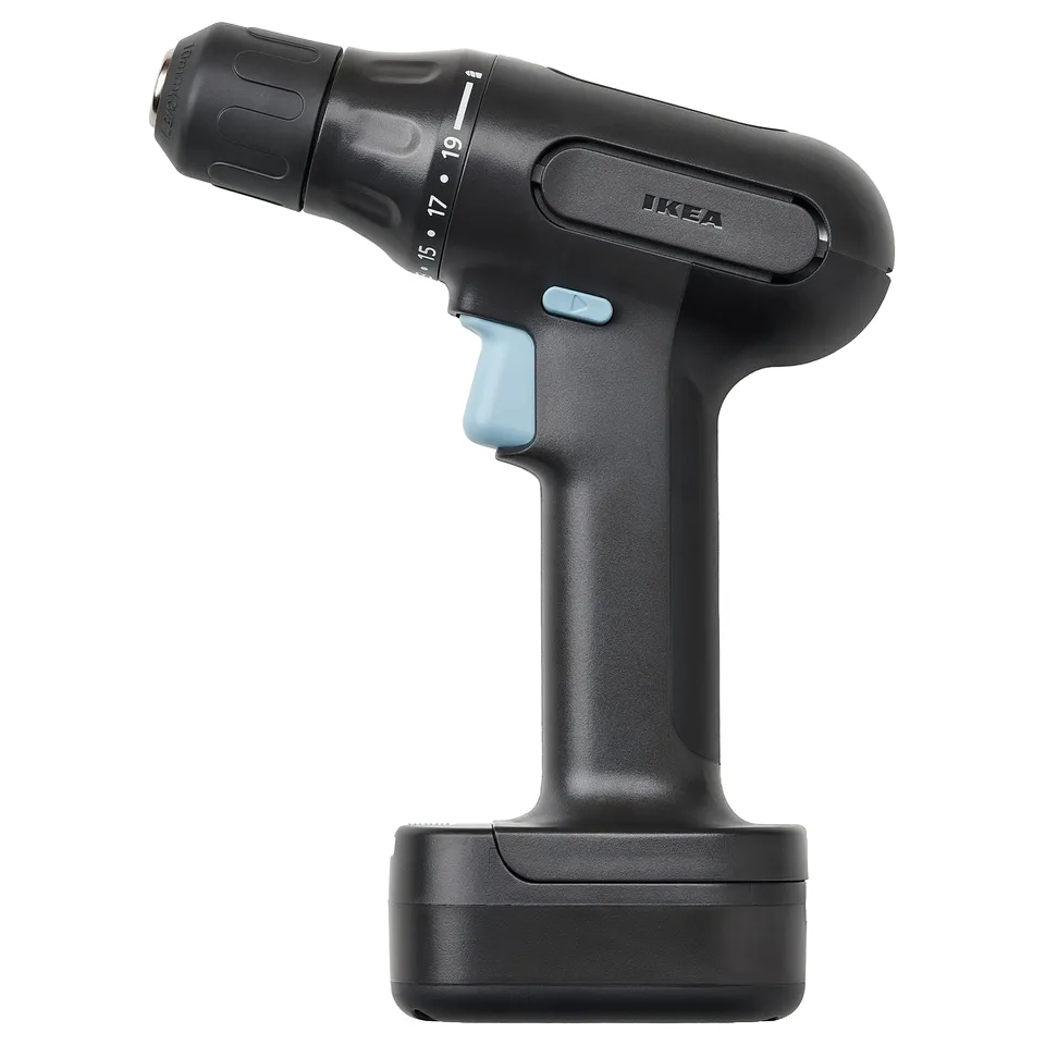Displays a black ikea TRIXIG cordless drill with a blue switch, standing upright. It has a sleek design with a rubberized handle for grip.