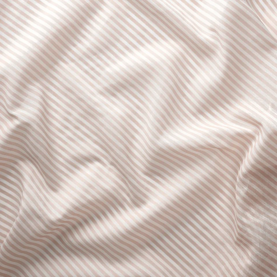 Soft, wavy stripes on sheer rose curtain, showcasing quality fabric texture and elegant design.