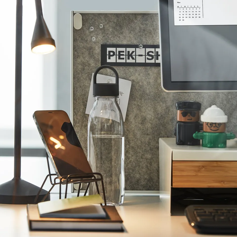 Desk with phone stand, water bottle, lamp, TROTTEN double-sided pin board.