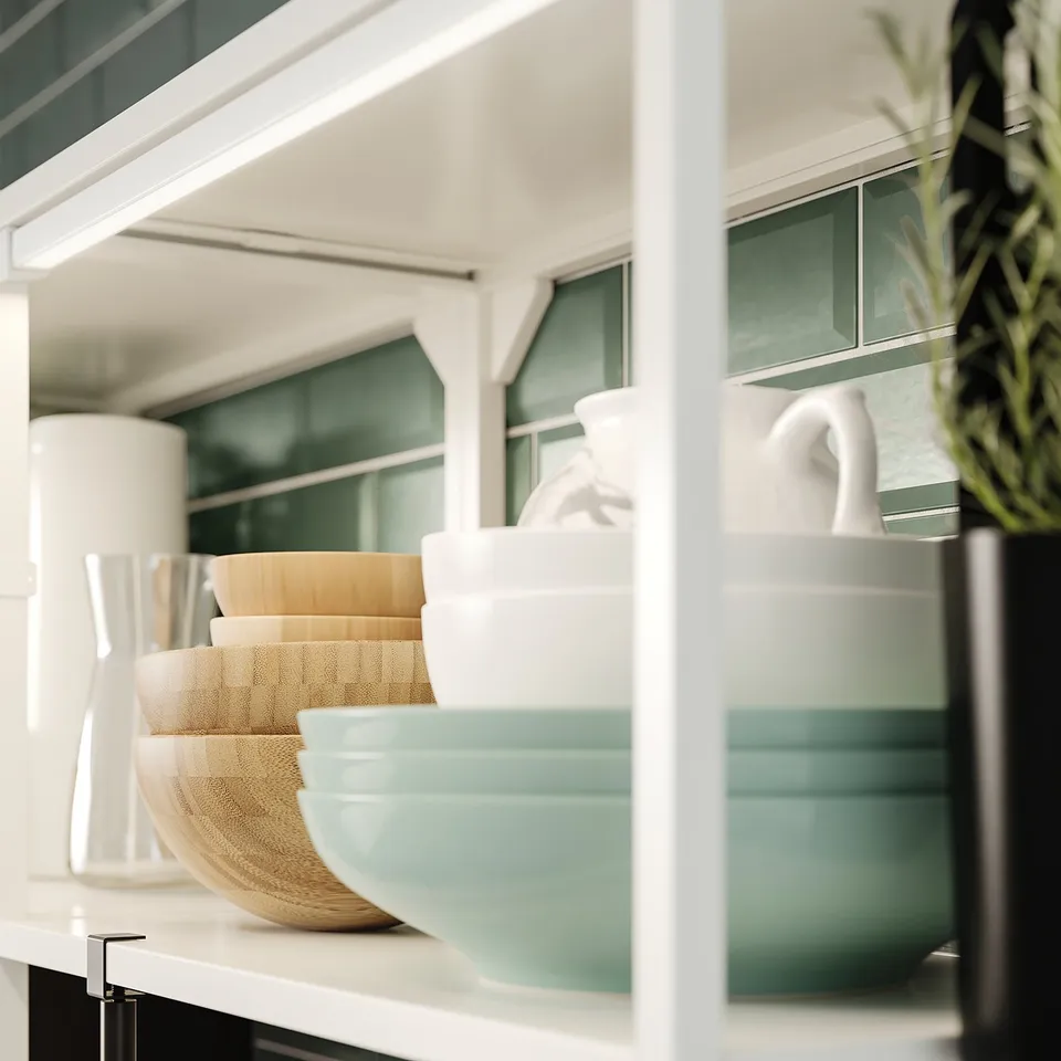 Kitchen shelf with bowls, vases, and plant. Wooden, white, stainless steel.
