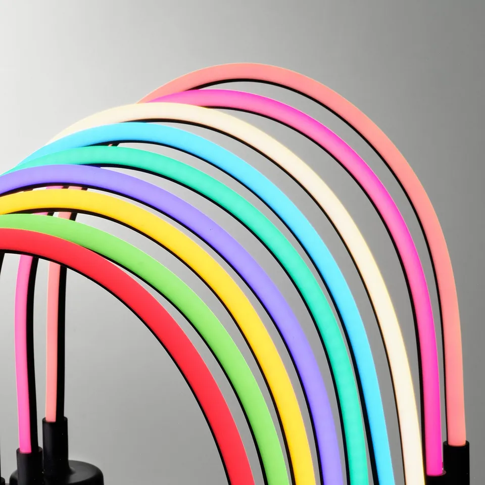 Multi-colored led lamp arching vibrantly against grey backdrop.