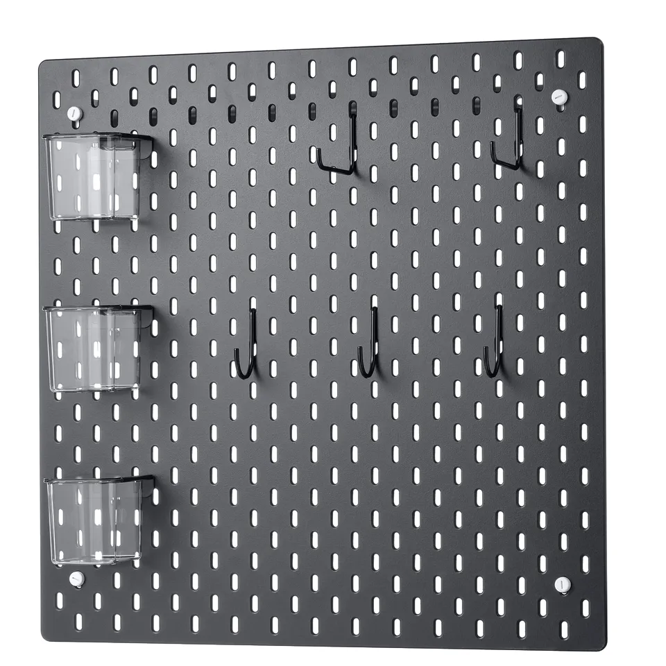 A grey SKÅDIS pegboard with hooks and containers. Its a wall-mounted organiser with a grid pattern for custom arrangement.