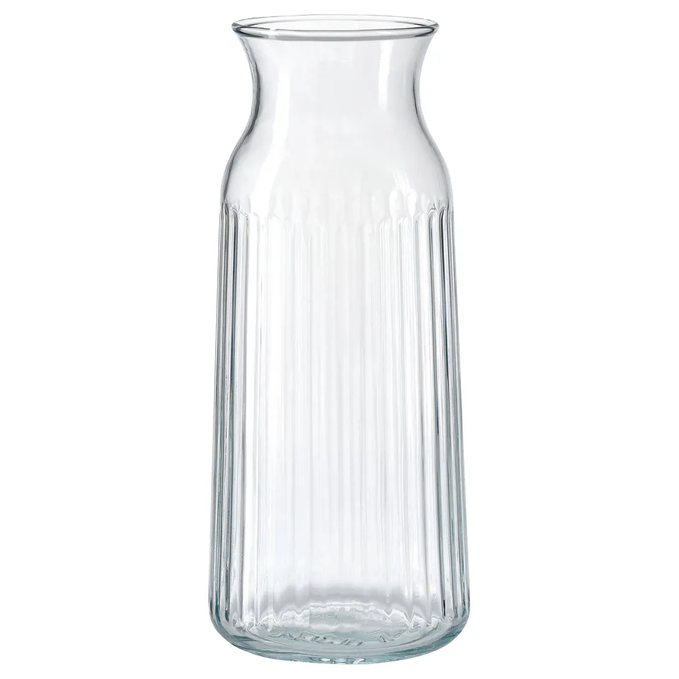 A clear, vertical VARDAGEN glass carafe with a ribbed design, perfect for serving beverages or as a vase.