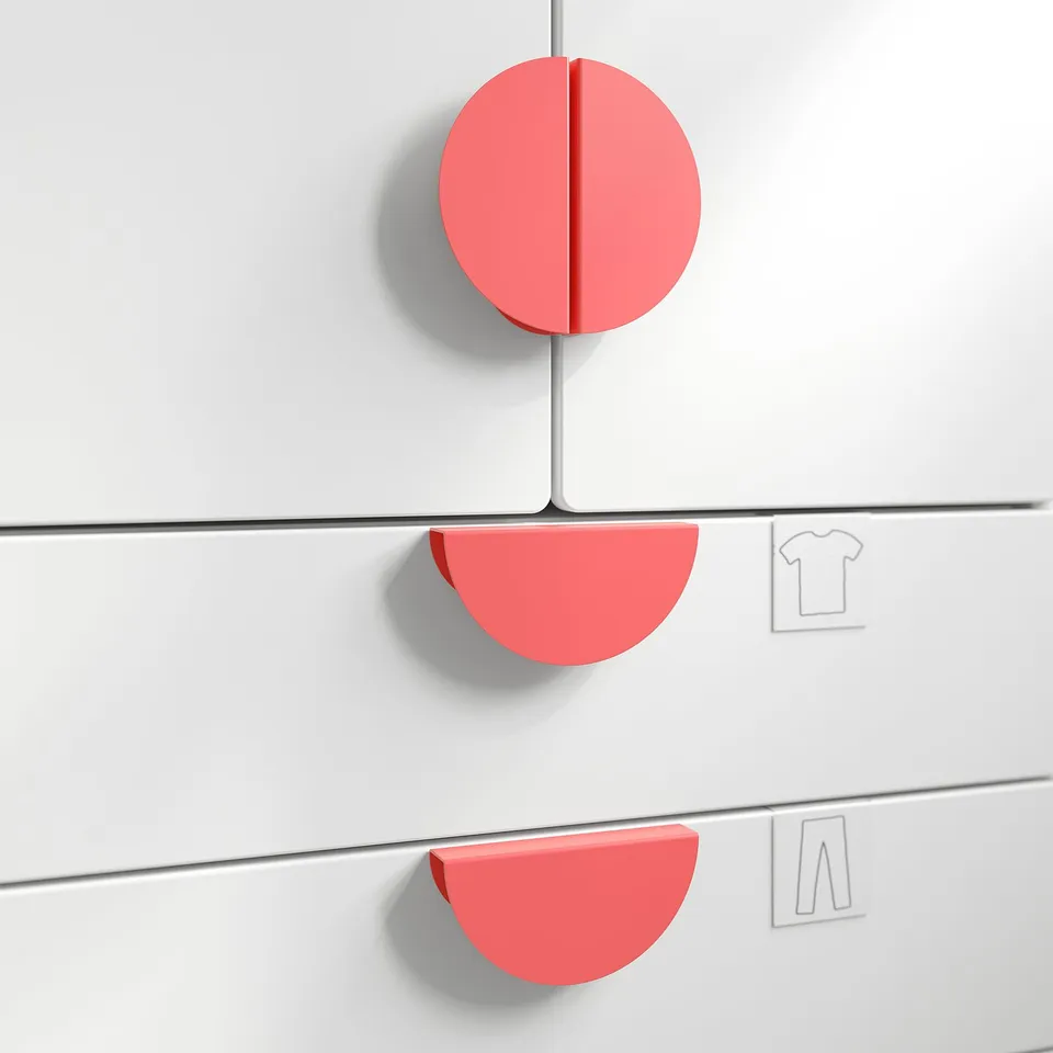 Red circular wall knobs, likely handles for storage, mounted on white wall.