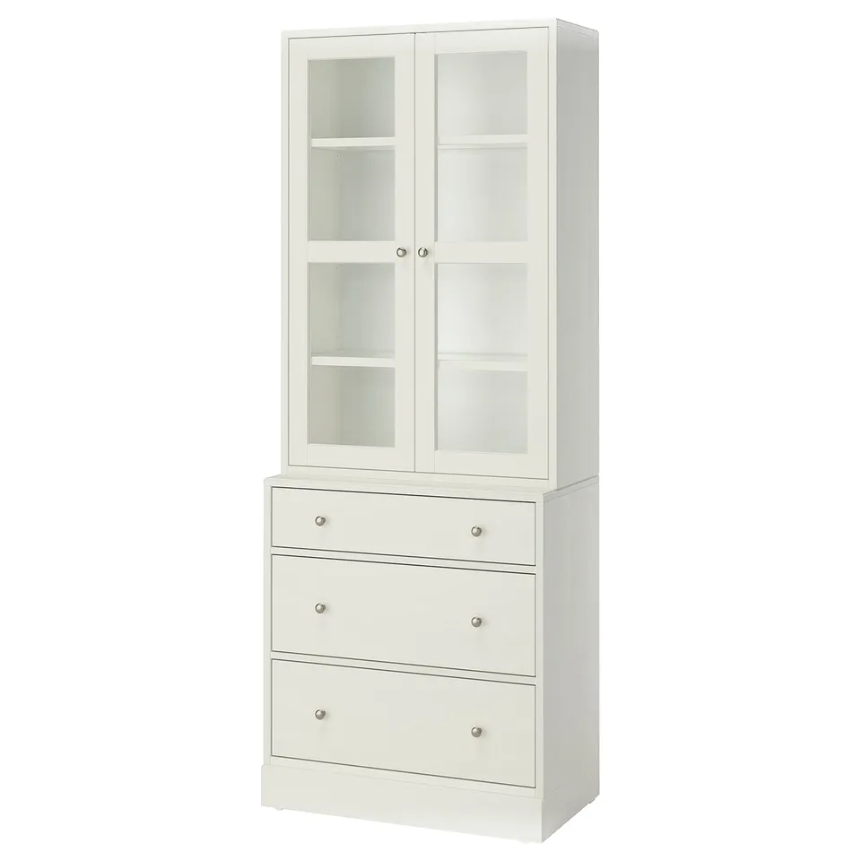 White HAVSTA set: glass cabinet, pine chest with metal handles.