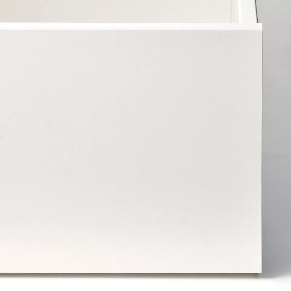 White drawer interior of KOMPLEMENT unit, showcasing smooth, clean surface ready for organising items.