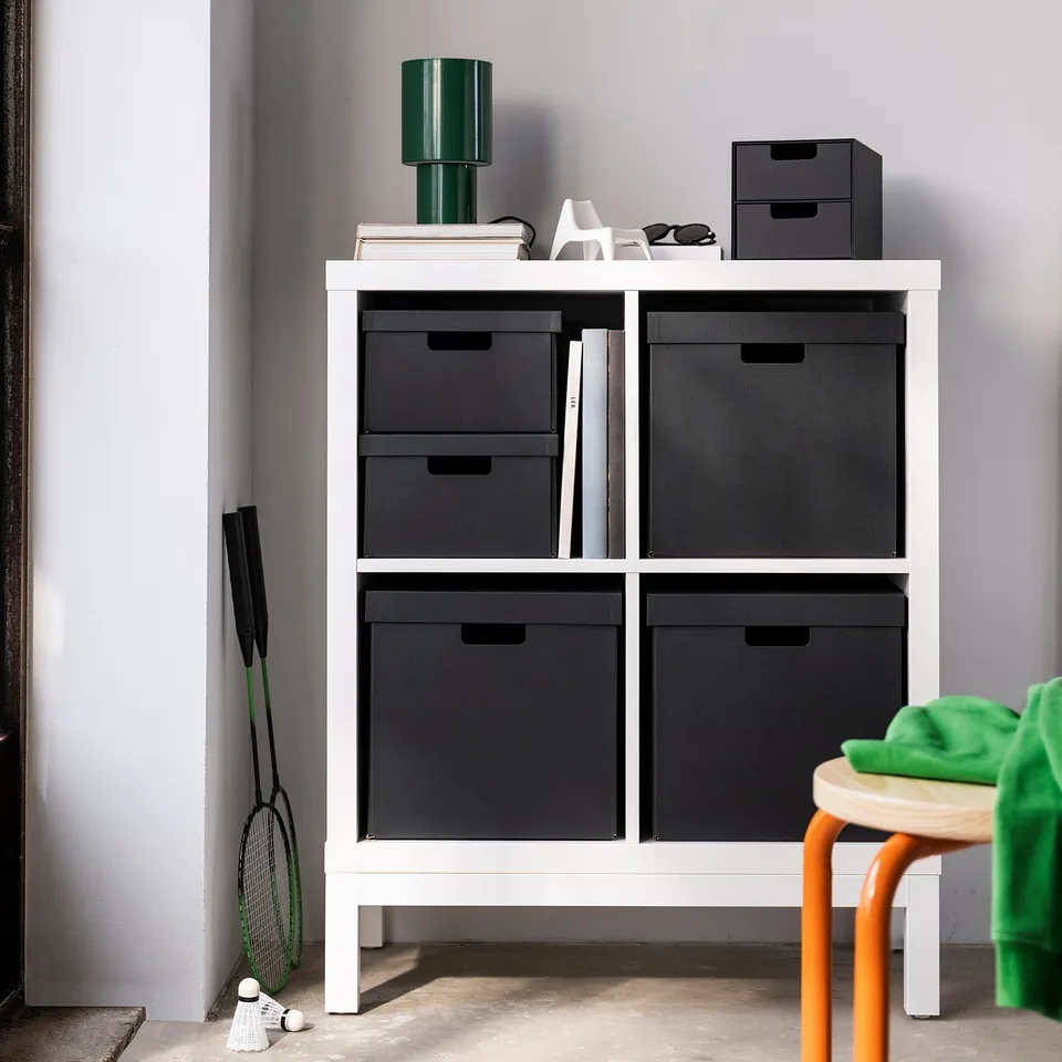 White FJÄDERHARV boxes on shelf, black, rectangular, durable paperboard, perfect for kallax, fits gadgets or accessories.