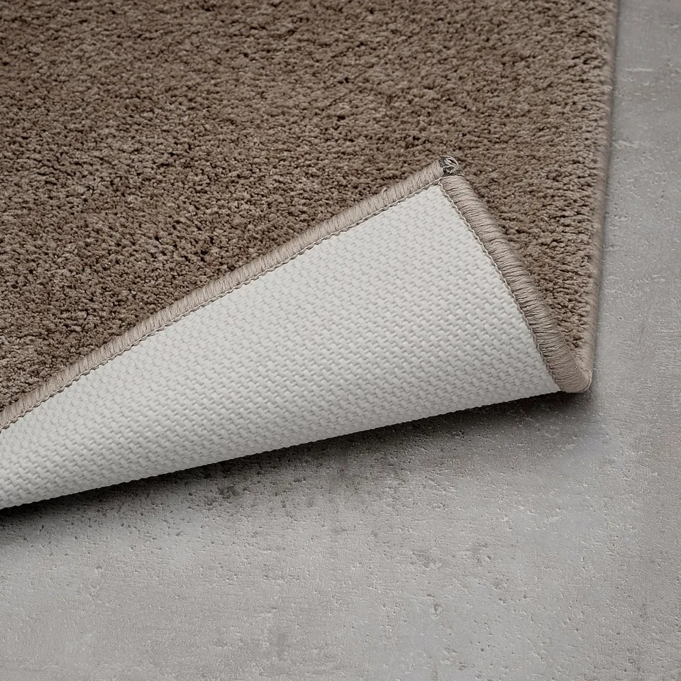 Close-up view of mats soft, textured top and grippy latex backing for safety and stability.