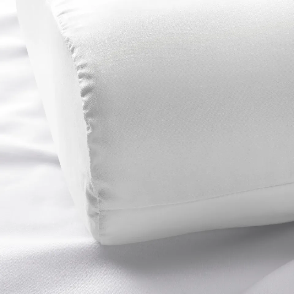 Soft, white bedding with fine stitching, showcasing high-quality cotton and lyocell fabric.