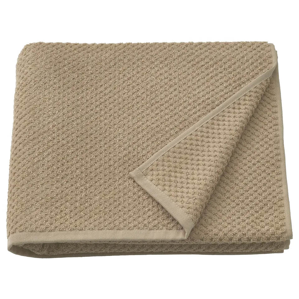 Folded beige GULVIAL cotton towel, textured, soft, 150gsm.