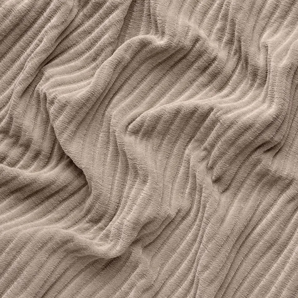Close-up of textured, soft corduroy fabric with deep, wide wales, showcasing its plush, comfortable quality.