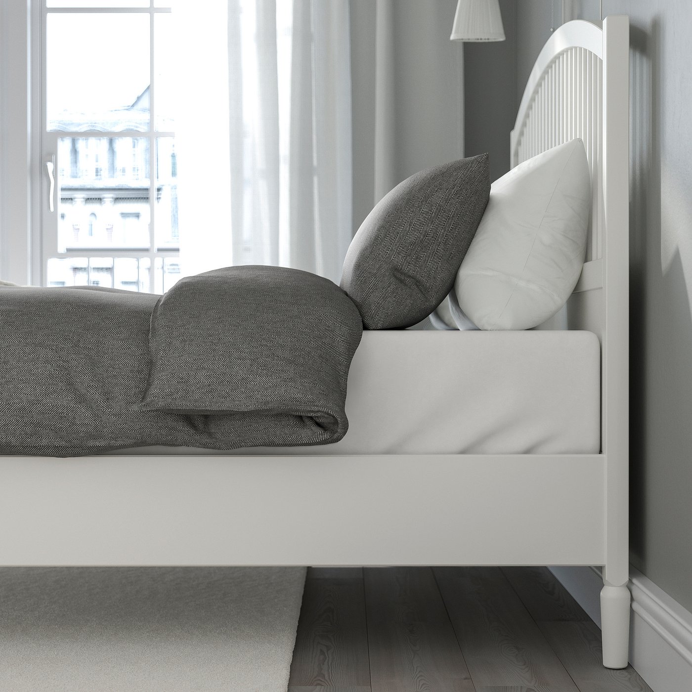 Adjustable white bed with grey bedding, high headboard, and under-bed storage.