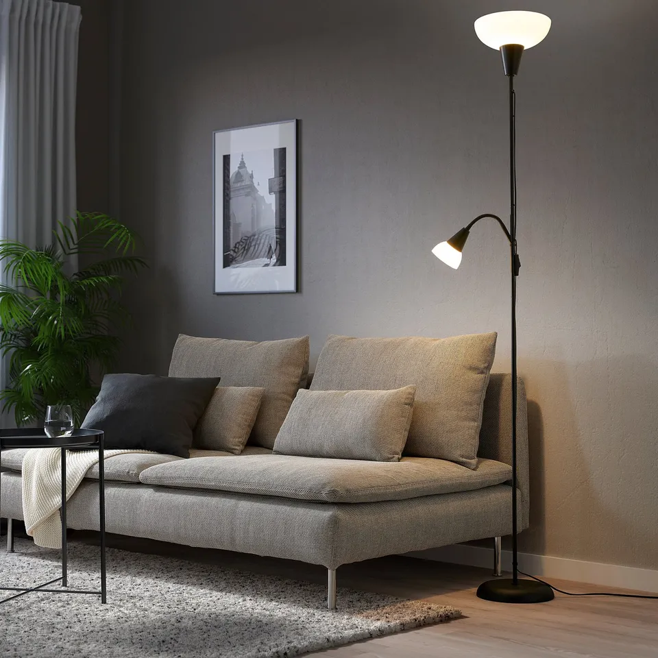 Modern living room with TÅGARP lamp, sofa, and decor.